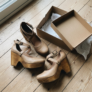 Customer unboxing photo of khaki wedge heels
