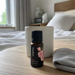Customer review photo of the rose essential oil bottle on a bedside table