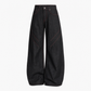 Side angle of wide leg jeans falling from hip to top of sneaker