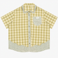 Green plaid short sleeve shirt with doll collar, side profile view